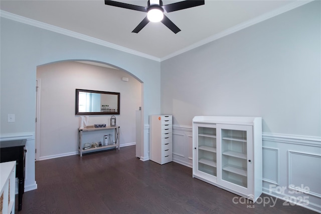 334 Kennerly Center Dr, Mooresville, NC 28115 - unfurnished room with arched walkways, a ceiling fan, crown molding, and dark wood-style flooring