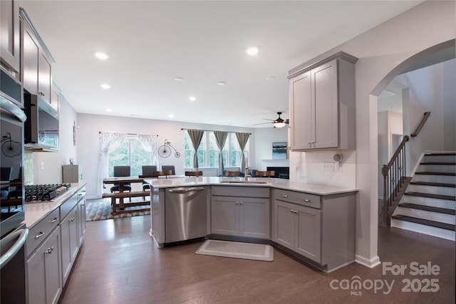 334 Kennerly Center Dr, Mooresville, NC 28115 - kitchen with stainless steel appliances, gray cabinetry, a ceiling fan, light countertops, and a peninsula
