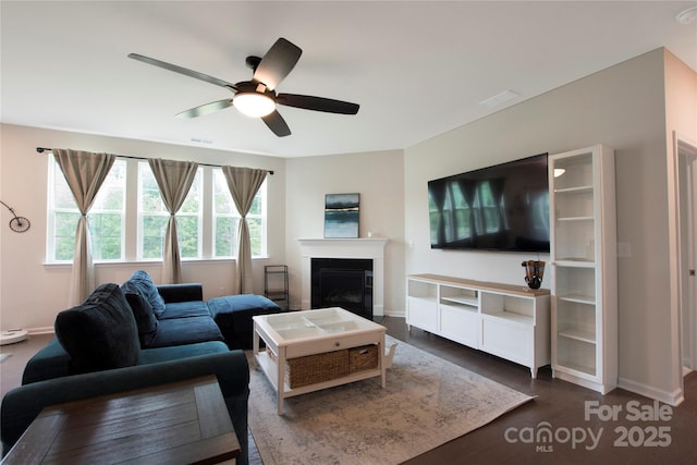 334 Kennerly Center Dr, Mooresville, NC 28115 - living area featuring a ceiling fan, a glass covered fireplace, and dark wood finished floors