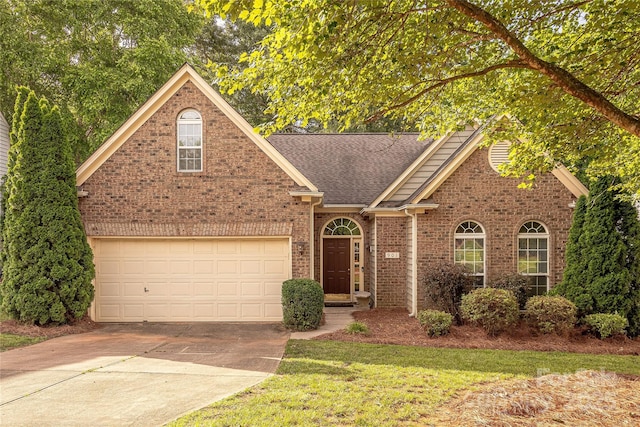 901 Clearbrook Rd, Matthews, NC 28105 - view of front facade with concrete driveway, brick siding, a shingled roof, and an attached garage