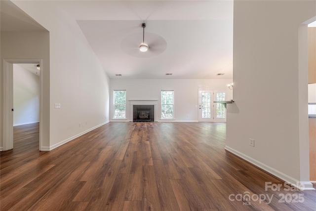 901 Clearbrook Rd, Matthews, NC 28105 - unfurnished living room featuring a ceiling fan, dark wood-type flooring, and a fireplace with flush hearth