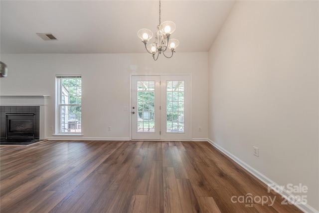 901 Clearbrook Rd, Matthews, NC 28105 - unfurnished living room with dark wood-type flooring, a chandelier, a fireplace, and lofted ceiling