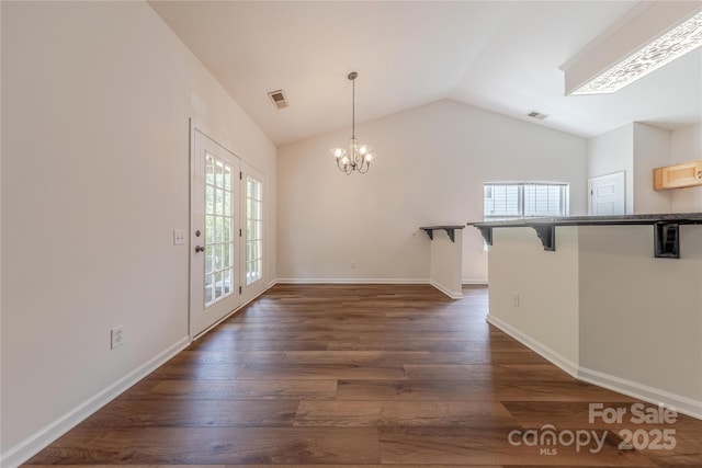 901 Clearbrook Rd, Matthews, NC 28105 - unfurnished dining area featuring vaulted ceiling, a chandelier, and dark wood-style floors