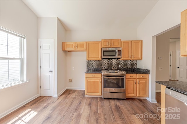 901 Clearbrook Rd, Matthews, NC 28105 - kitchen featuring light wood-style floors, stainless steel appliances, decorative backsplash, vaulted ceiling, and dark stone countertops