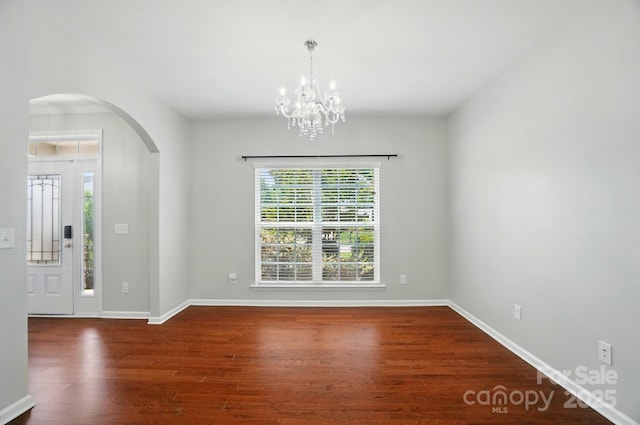 8115 Kelburn Ln, Charlotte, NC 28273 - entrance foyer with healthy amount of natural light, wood finished floors, arched walkways, and a chandelier