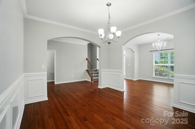 8115 Kelburn Ln, Charlotte, NC 28273 - unfurnished room with a chandelier, ornamental molding, arched walkways, a wainscoted wall, and wood finished floors