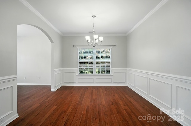 8115 Kelburn Ln, Charlotte, NC 28273 - unfurnished dining area with arched walkways, a chandelier, dark wood-style floors, crown molding, and a wainscoted wall