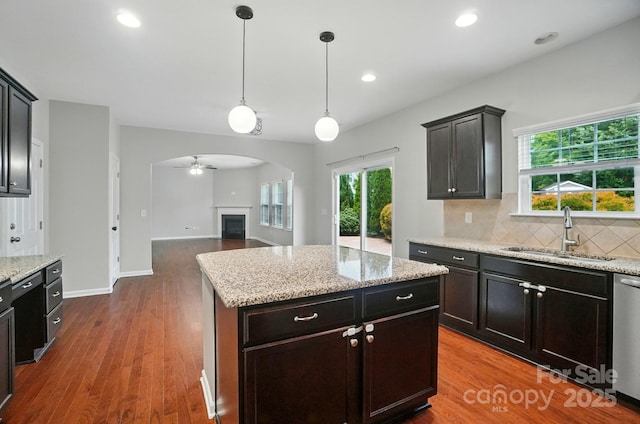 8115 Kelburn Ln, Charlotte, NC 28273 - kitchen featuring arched walkways, tasteful backsplash, dark wood-style flooring, plenty of natural light, and recessed lighting