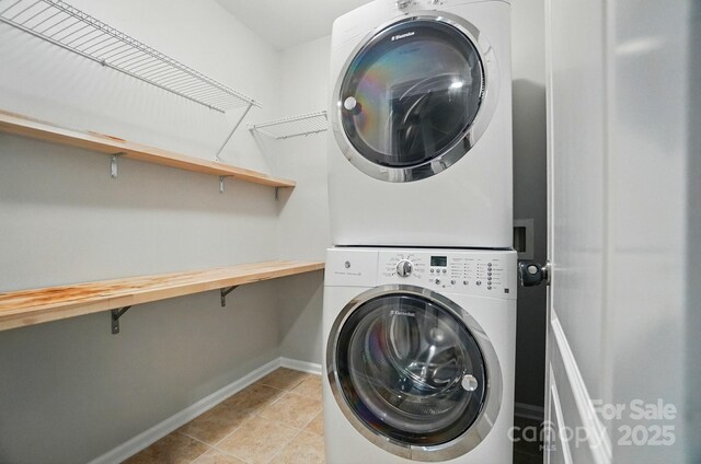 8115 Kelburn Ln, Charlotte, NC 28273 - washroom featuring stacked washing machine and dryer and light tile patterned floors