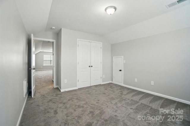 8115 Kelburn Ln, Charlotte, NC 28273 - unfurnished bedroom with vaulted ceiling, carpet flooring, and a closet