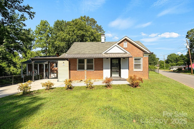 115 E Catawba St, Morganton, NC 28655 - bungalow-style home with concrete driveway, brick siding, a chimney, an attached carport, and a shingled roof