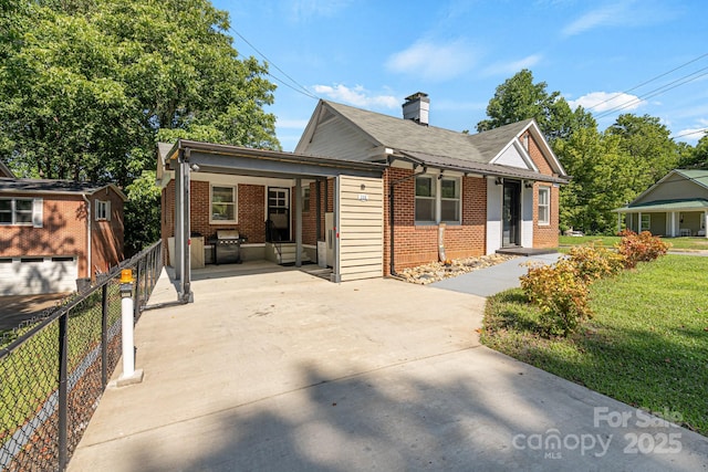 115 E Catawba St, Morganton, NC 28655 - view of front of property featuring brick siding and a chimney