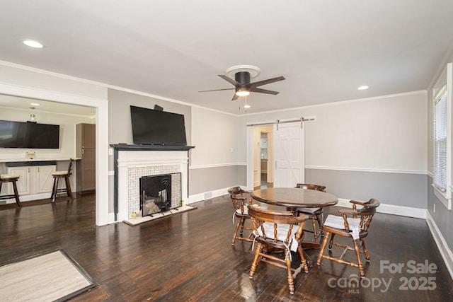115 E Catawba St, Morganton, NC 28655 - dining area with a barn door, wood finished floors, a ceiling fan, recessed lighting, and a fireplace