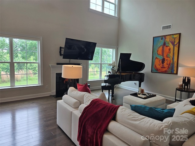 5000 Britannia Blvd, Waxhaw, NC 28173 - living room with a towering ceiling, baseboards, wood finished floors, and a fireplace with flush hearth