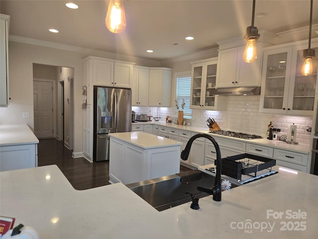 5000 Britannia Blvd, Waxhaw, NC 28173 - kitchen with stainless steel appliances, ornamental molding, light countertops, white cabinets, and recessed lighting