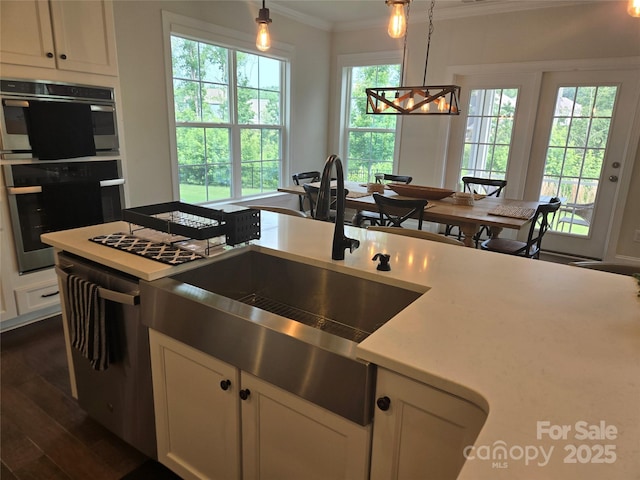 5000 Britannia Blvd, Waxhaw, NC 28173 - kitchen featuring ornamental molding, stainless steel appliances, white cabinets, a chandelier, and pendant lighting