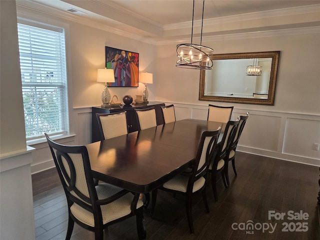 5000 Britannia Blvd, Waxhaw, NC 28173 - dining area featuring dark wood finished floors, a decorative wall, crown molding, a chandelier, and wainscoting