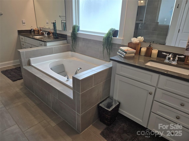 5000 Britannia Blvd, Waxhaw, NC 28173 - bathroom with vanity, a bath, tile patterned floors, and a stall shower