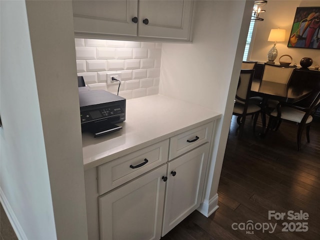 5000 Britannia Blvd, Waxhaw, NC 28173 - kitchen with tasteful backsplash, white cabinetry, dark wood finished floors, and light countertops