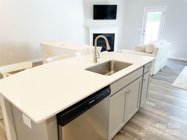 8060 Scarlet Maple Ln, Tega Cay, SC 29708 - kitchen with stainless steel dishwasher, a center island with sink, light wood-style floors, and open floor plan