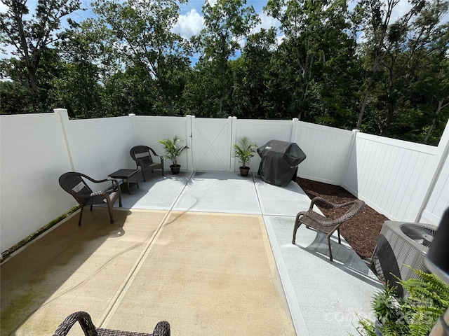8060 Scarlet Maple Ln, Tega Cay, SC 29708 - fenced backyard featuring a patio, a grill, a gate, and view of wooded area
