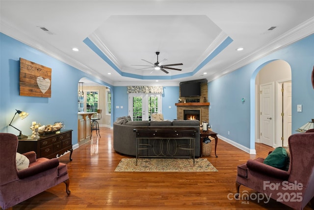 1912 Dawnhurst Ln, York, SC 29745 - living room with arched walkways, ornamental molding, a raised ceiling, a ceiling fan, and wood finished floors