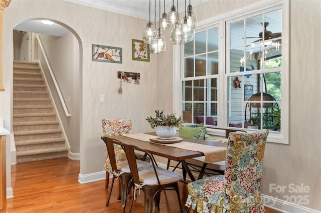 1912 Dawnhurst Ln, York, SC 29745 - dining space featuring stairs, wood finished floors, arched walkways, and ornamental molding