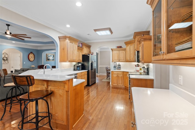 1912 Dawnhurst Ln, York, SC 29745 - kitchen with arched walkways, appliances with stainless steel finishes, a peninsula, a kitchen bar, and tasteful backsplash