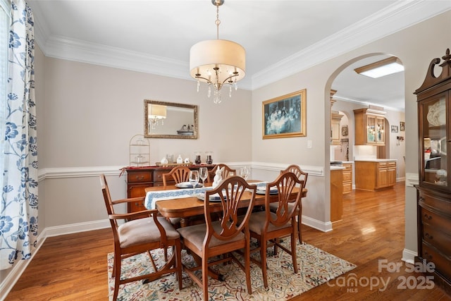 1912 Dawnhurst Ln, York, SC 29745 - dining room with arched walkways, crown molding, light wood-type flooring, and a chandelier