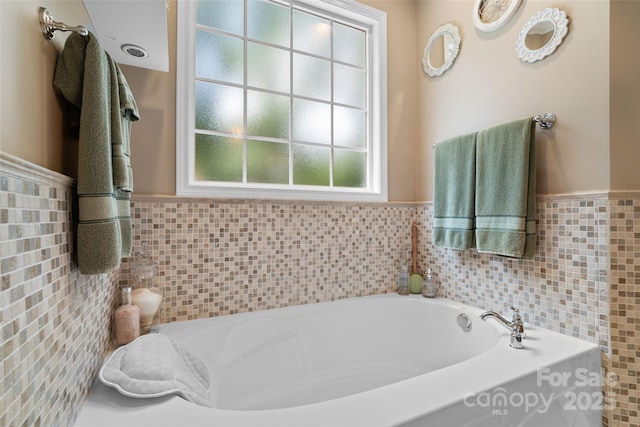 1912 Dawnhurst Ln, York, SC 29745 - bathroom featuring tile walls, a bath, and a wainscoted wall