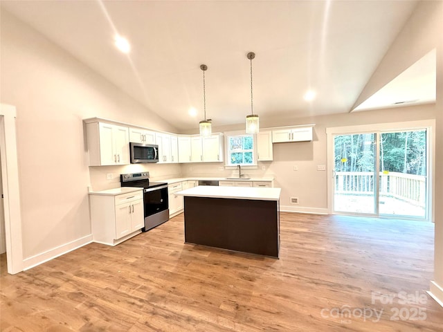 2330 Neill Rd, Lancaster, SC 29720 - kitchen featuring stainless steel appliances, vaulted ceiling, light wood finished floors, light countertops, and a kitchen island
