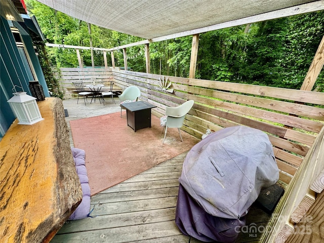 401 Church St, Warrenton, NC 27589 - wooden deck with a grill and outdoor dining area