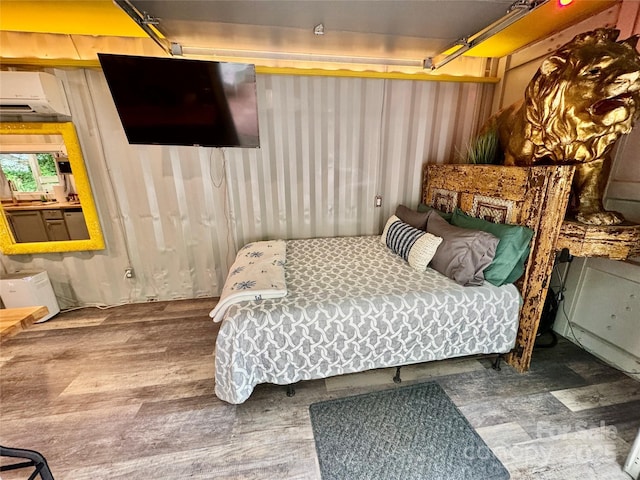 401 Church St, Warrenton, NC 27589 - bedroom with a wall mounted air conditioner and wood finished floors