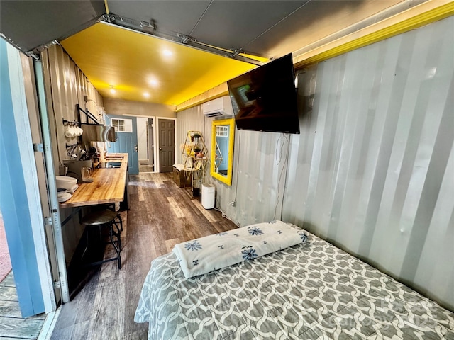401 Church St, Warrenton, NC 27589 - bedroom with dark wood-type flooring and an AC wall unit