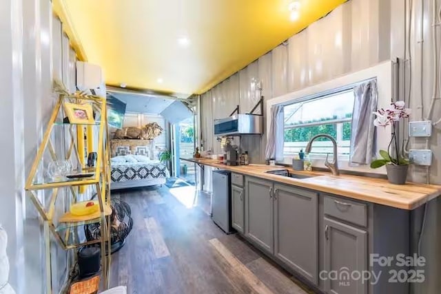 401 Church St, Warrenton, NC 27589 - kitchen featuring gray cabinets, wooden counters, and dark wood finished floors