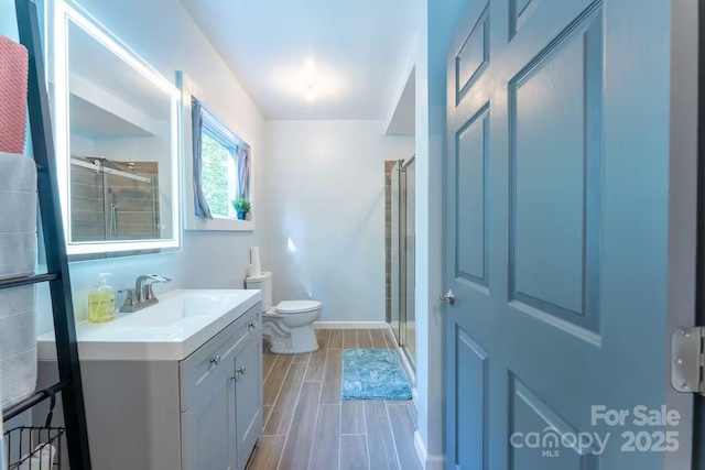 401 Church St, Warrenton, NC 27589 - bathroom with vanity, a shower with shower door, and wood tiled floors
