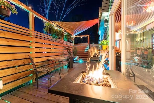 401 Church St, Warrenton, NC 27589 - deck at twilight featuring an outdoor fire pit