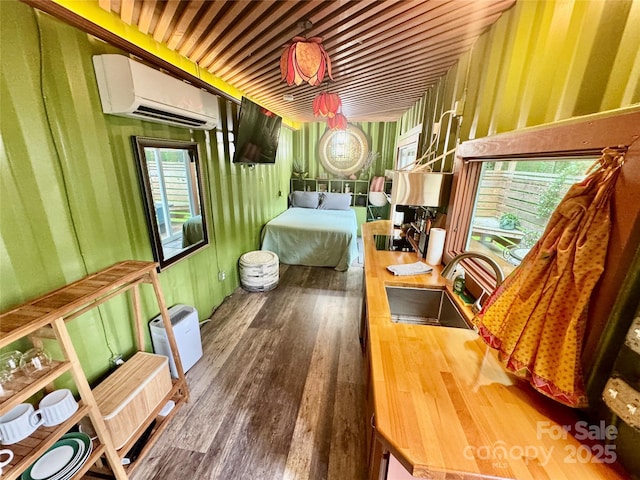 401 Church St, Warrenton, NC 27589 - bedroom with an AC wall unit and wood finished floors