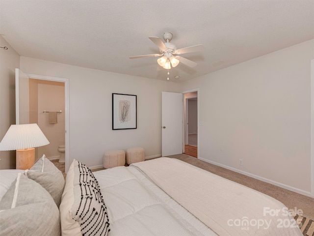 713 Springfield Dr NW, Concord, NC 28027 - bedroom with baseboards, carpet floors, a ceiling fan, and connected bathroom