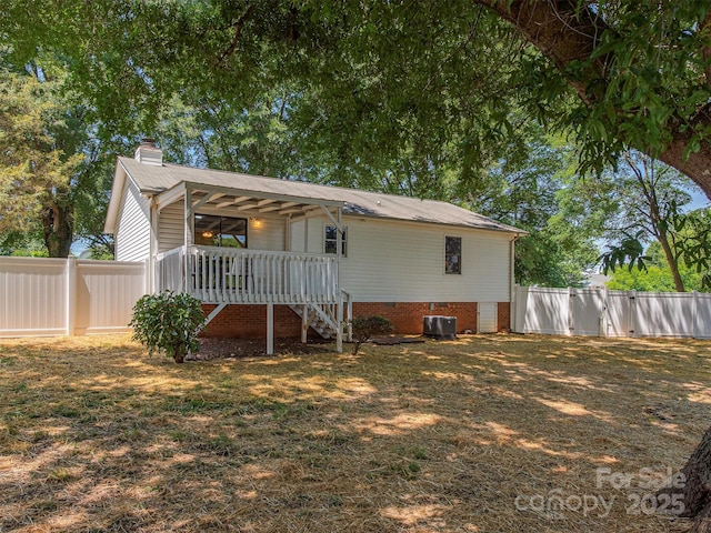 713 Springfield Dr NW, Concord, NC 28027 - back of property with a chimney, a fenced backyard, a porch, central AC, and stairs