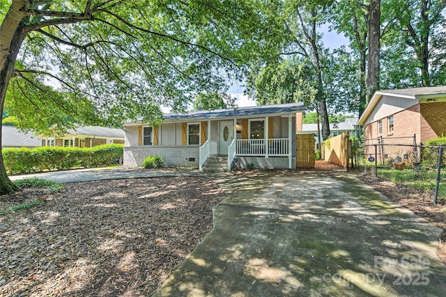 3020 Stancill Pl, Charlotte, NC 28205 - ranch-style house with covered porch, concrete driveway, brick siding, and crawl space