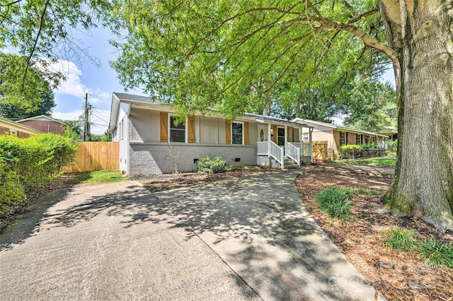 3020 Stancill Pl, Charlotte, NC 28205 - ranch-style home with brick siding, a porch, board and batten siding, and concrete driveway