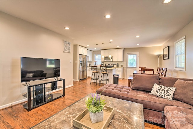 3020 Stancill Pl, Charlotte, NC 28205 - living room with recessed lighting, wood finished floors, and baseboards