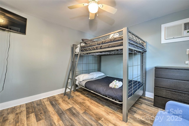 3020 Stancill Pl, Charlotte, NC 28205 - bedroom featuring wood finished floors, baseboards, a ceiling fan, and a wall unit AC