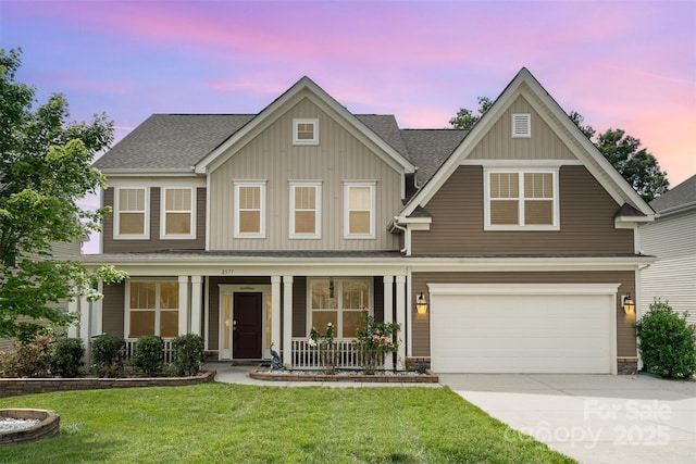 2577 Shoal Park Rd, Concord, NC 28027 - view of front facade with a porch, board and batten siding, a garage, concrete driveway, and a yard