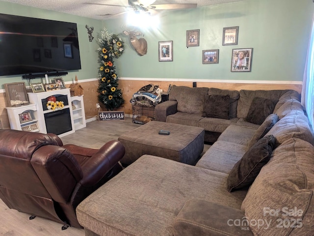 5077 Edney Ct, Granite Falls, NC 28630 - living area with wood finished floors, ceiling fan, a textured ceiling, and a wainscoted wall