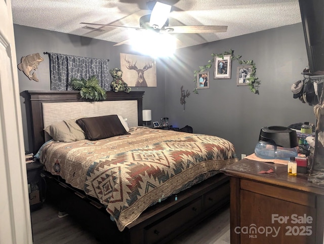 5077 Edney Ct, Granite Falls, NC 28630 - bedroom featuring wood finished floors, a textured ceiling, and ceiling fan