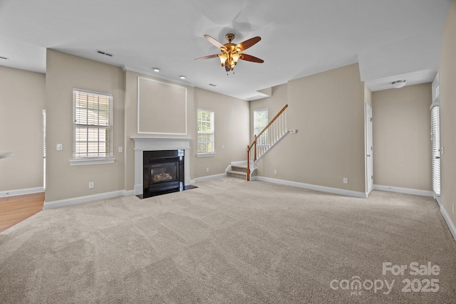 10349 Alvarado Way, Charlotte, NC 28277 - unfurnished living room with light colored carpet, stairs, a fireplace with flush hearth, and ceiling fan