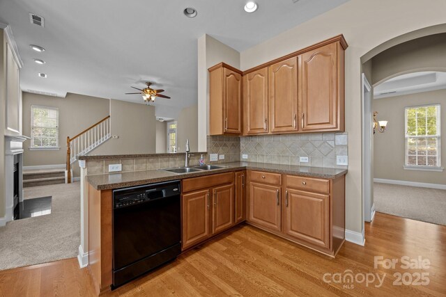 10349 Alvarado Way, Charlotte, NC 28277 - kitchen featuring black dishwasher, a ceiling fan, light wood finished floors, decorative backsplash, and arched walkways