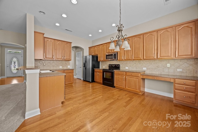 10349 Alvarado Way, Charlotte, NC 28277 - kitchen featuring black electric range, arched walkways, stainless steel microwave, fridge with ice dispenser, and light wood-style flooring